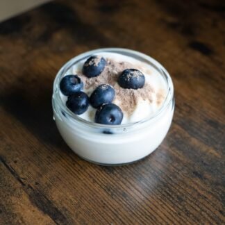 a bowl of ice cream with blueberries on top